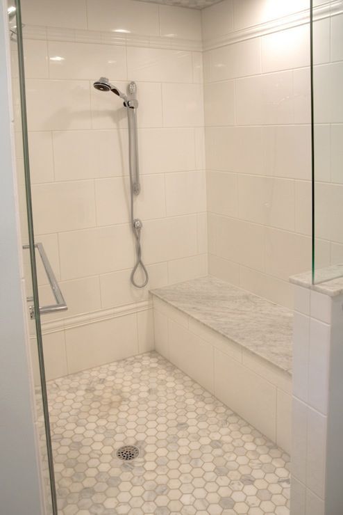 source: Lamantia website  Stunning walk-in shower with oversize white ceramic tile laid in a staggered brick pattern. The shower