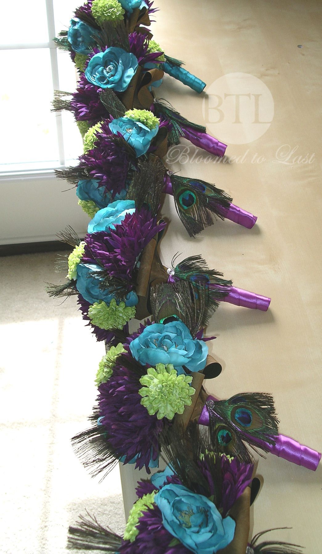 Stunning group of bridesmaids Peacock feather wedding bouquets all lined up and ready to go. Wouldn’t these be prefect for your