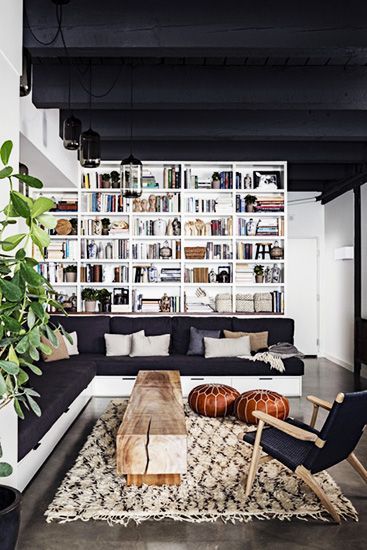 9 Must-Haves for a California Eclectic Home// layered bookshelves, Moroccan rug, leather pouf