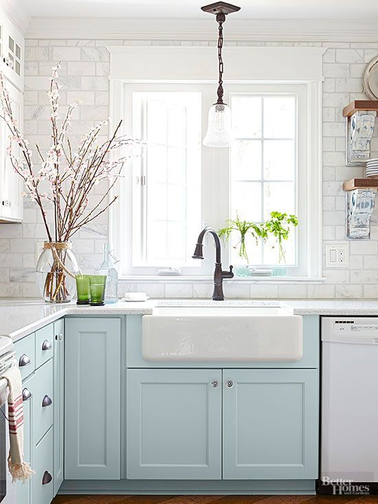 An enlarged window above the sink allows plenty of sunlight to stream into the cottage kitchen. An apron-front sink and oil-rubbed