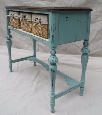 This was once a bottom to a radio cabinet.  We have re-purposed her by adding storage baskets and painted her teal.