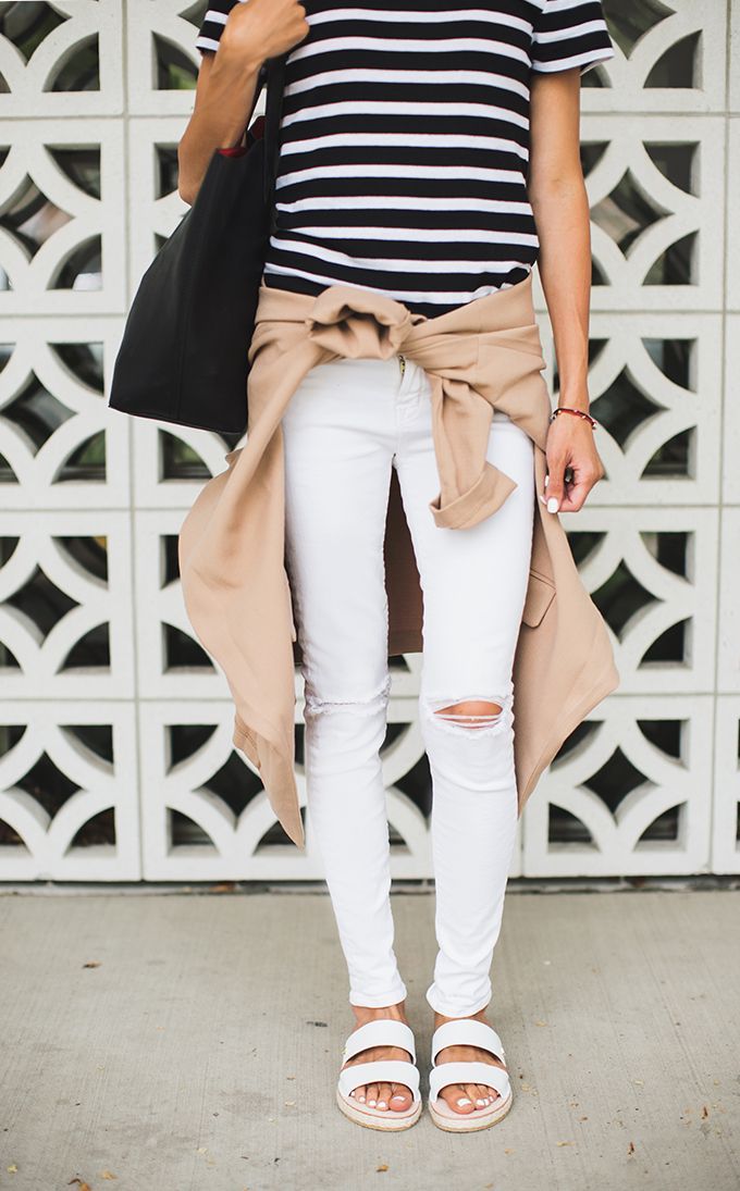 White distressed jeans, striped shirt, and camel colored cardigan
