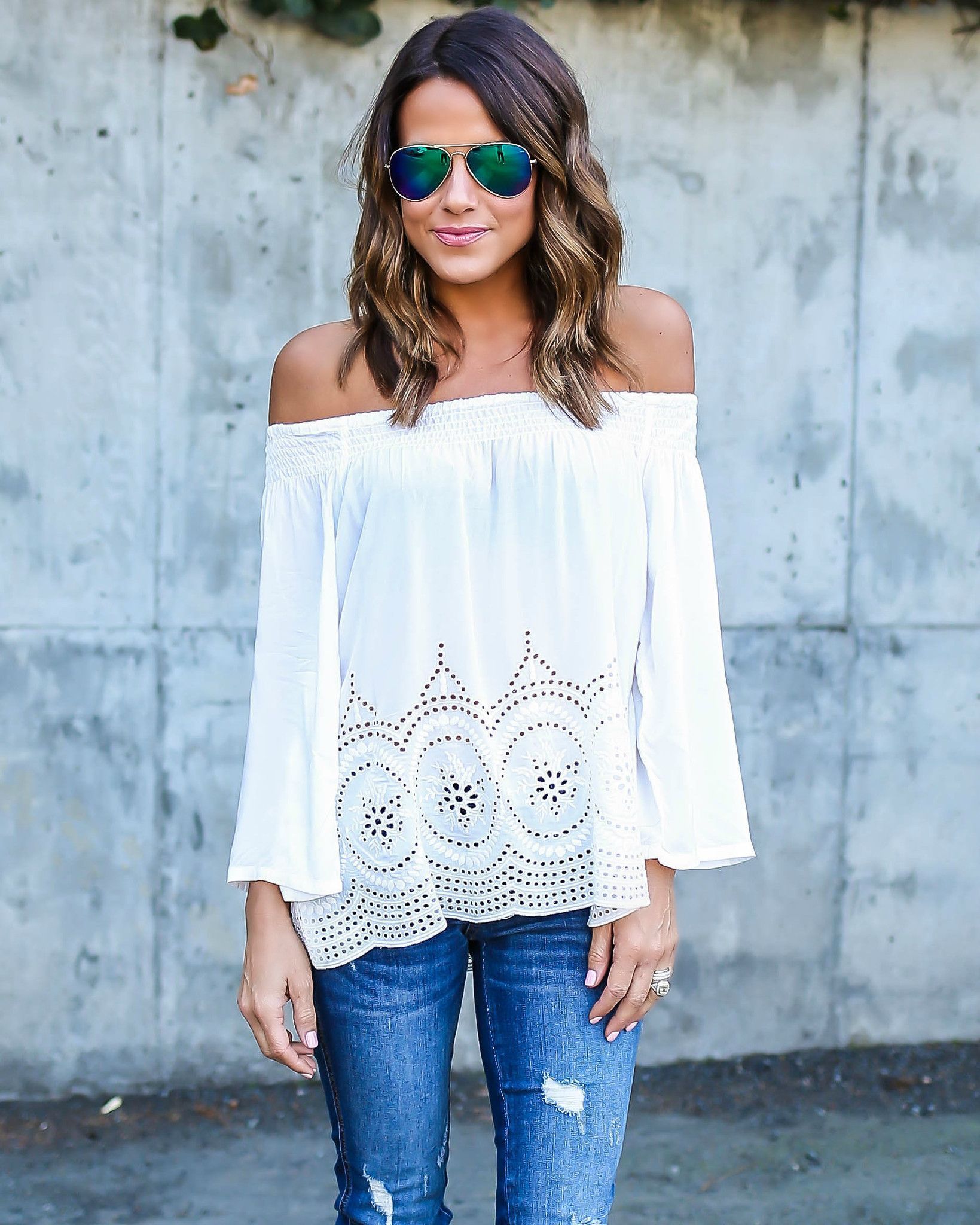 off the shoulder, navy top, distressed jeans and brown suede fringe heels