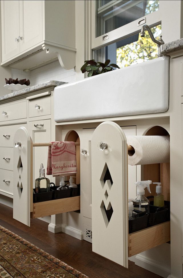 Beautiful carved, pull out kitchen drawers for towel, cleaning supplies, and paper towel storage