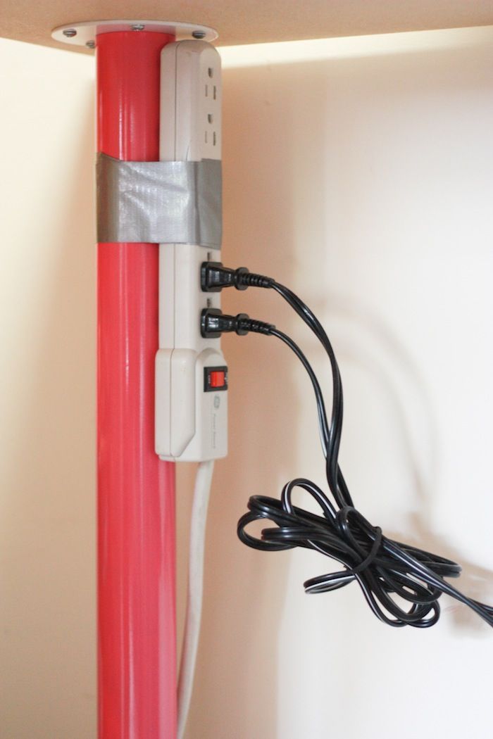 Duct tape it to a pole to keep cords off the floor