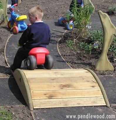 Roadway bridge – easy addition to a trike path.  This site has some other cool wooden designs for playgrou