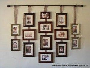 Wonderful idea for hanging a group of pictures without putting a million nail holes in the wall.