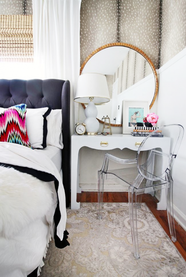 Chic bedroom featuring a chic side table/ vanity with a lucite chair and gilded mirror
