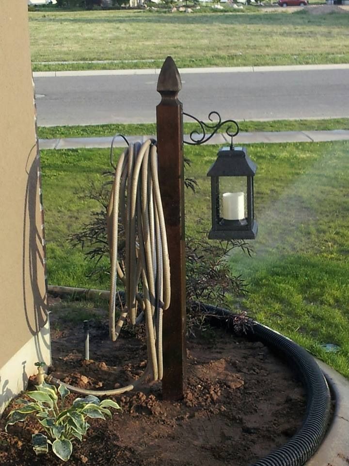 Lantern & Hose Holder from a wooden post. Love it!