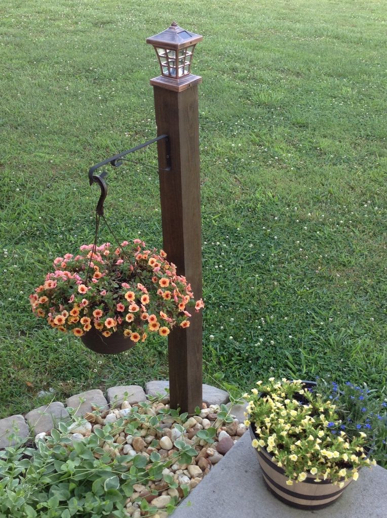 Lantern & Hose Holder from a wooden post. Love it!