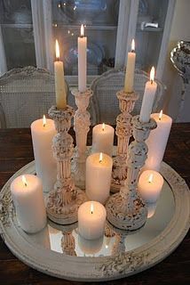 lovely grouping of candles and candlesticks – really makes a statement this way, perfect on the framed mir