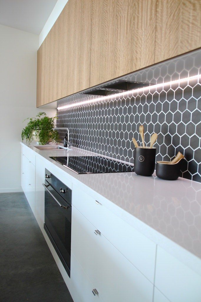 Split – Kitchen Detail White and timber, black hexagon feature tiles with recessed lighting Niche Desi