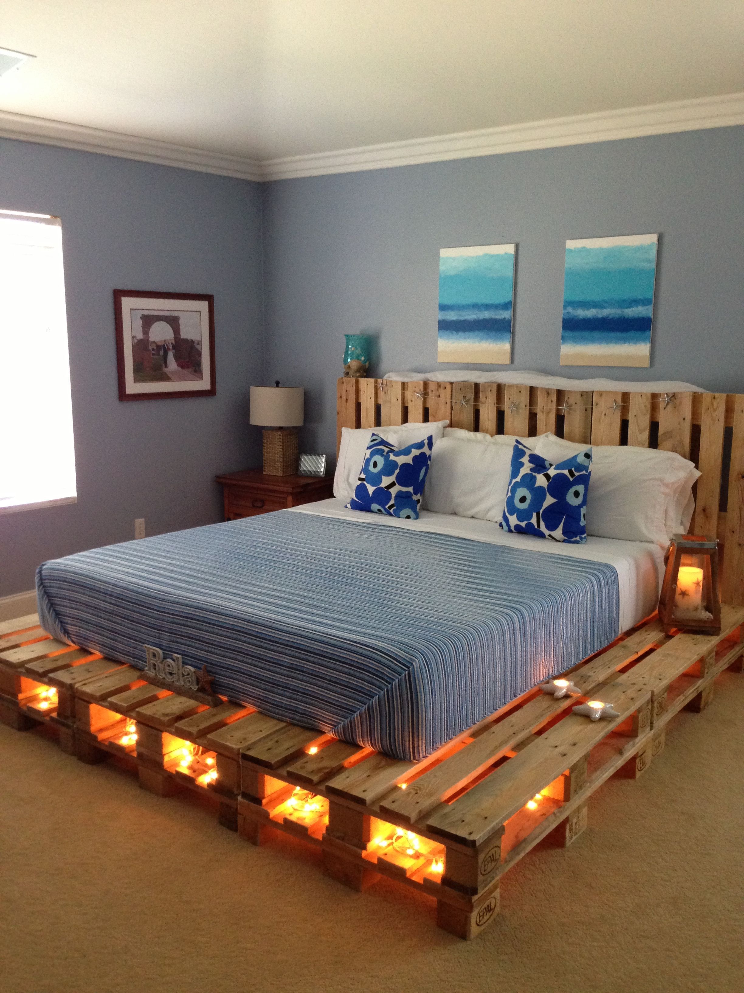 Ca king pallet bed made by hubby. Paintings above also painted by him and my daughter!