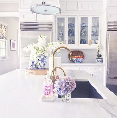 Now this is a dreamy white kitchen. White countertops, lights, and cabinets get…