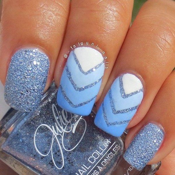 Sky blue and white Ombre nail art design. Additional glitter polish in metallic blue is added to give