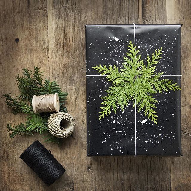 black wrapping paper w/ white paint splatter (snow) & evergreen (snowflake)…