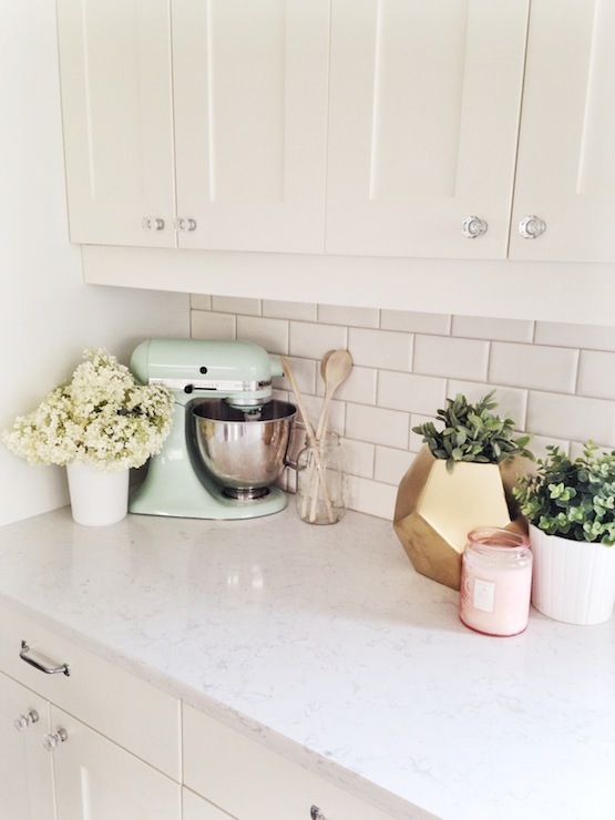 creamy white shaker style kitchen cabinets, subway tile back splash, crystal knobs