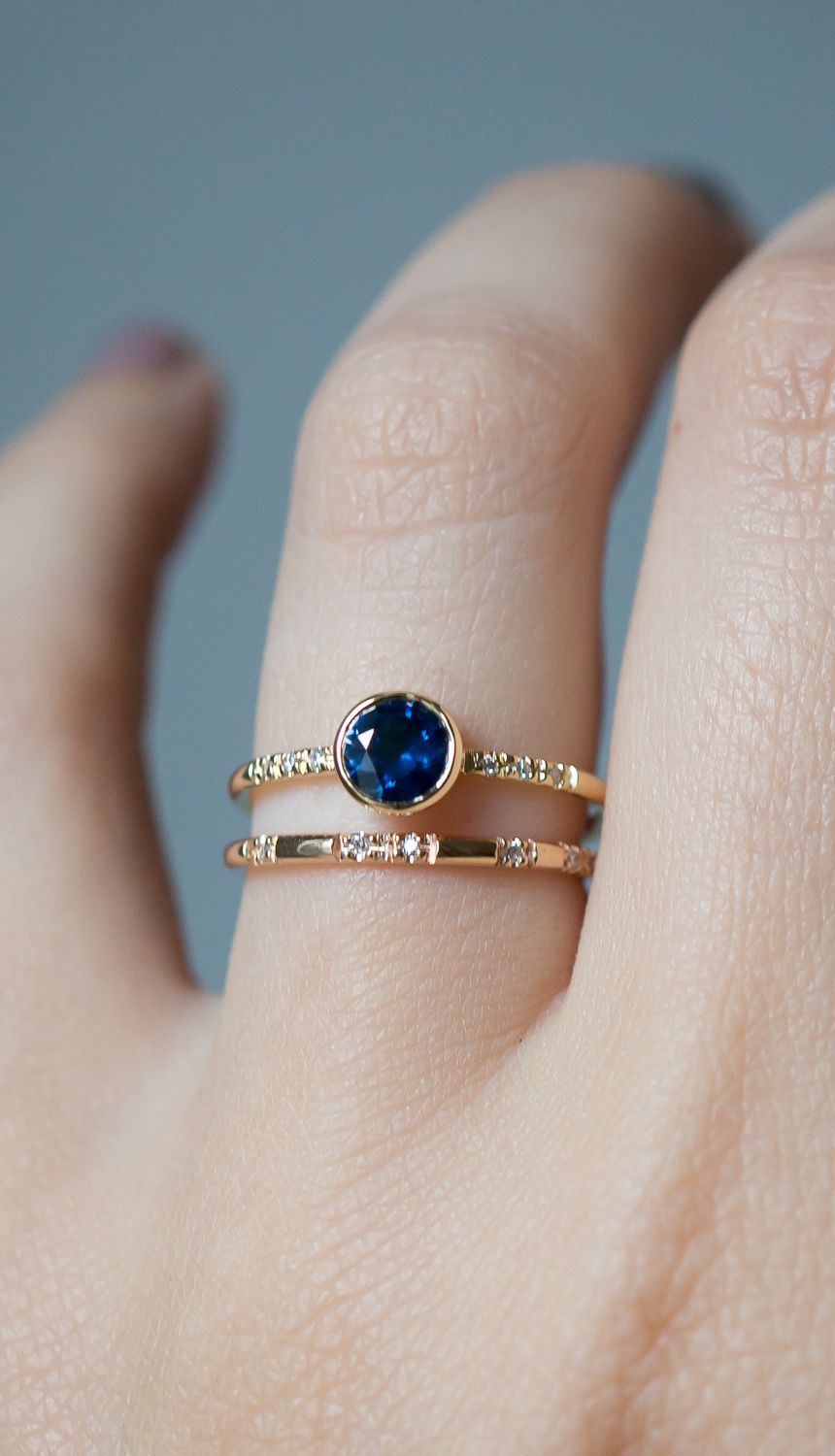 a  Classic deep blue sapphire engagement ring stands out set in 18k gold