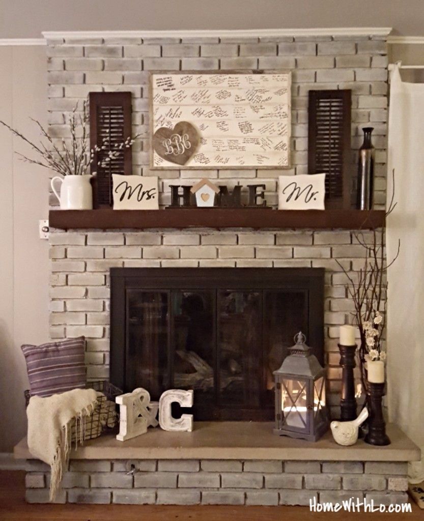 How I updated our fireplace by painting the outdated brass cover and used various techniques for whitewashing the brick.