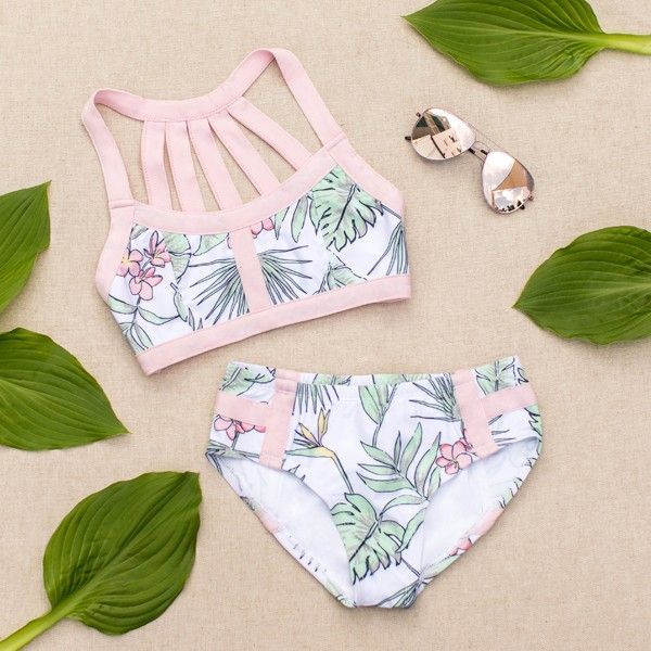 Featuring a beautiful strapped back detail and a lovely tropical inspired print, this swimsuit is the perfect go-to summer piece!