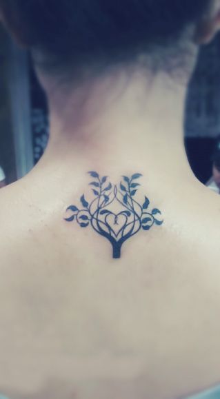 tree tattoo behind the neck with a heart hidden inside