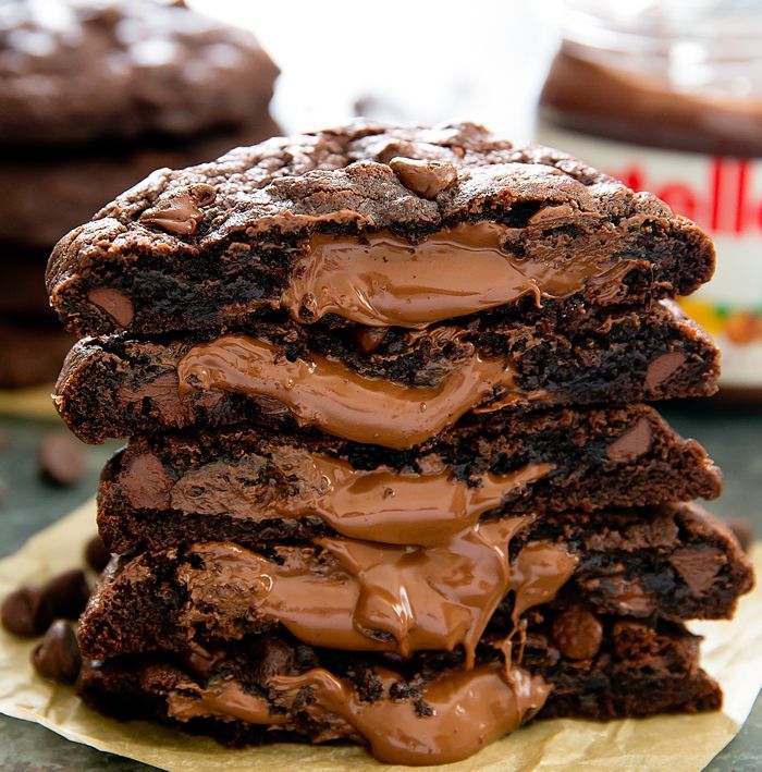 Oversized rich chocolate cookies are stuffed with Nutella. When you break the cookies open, they release a completely molten,