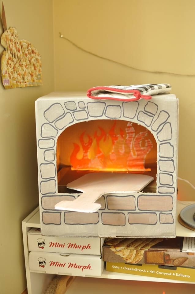 Cardboard pizza oven 2.0! I used string lights in the box below, and laminated tissue paper flames. So much fun for our pizza