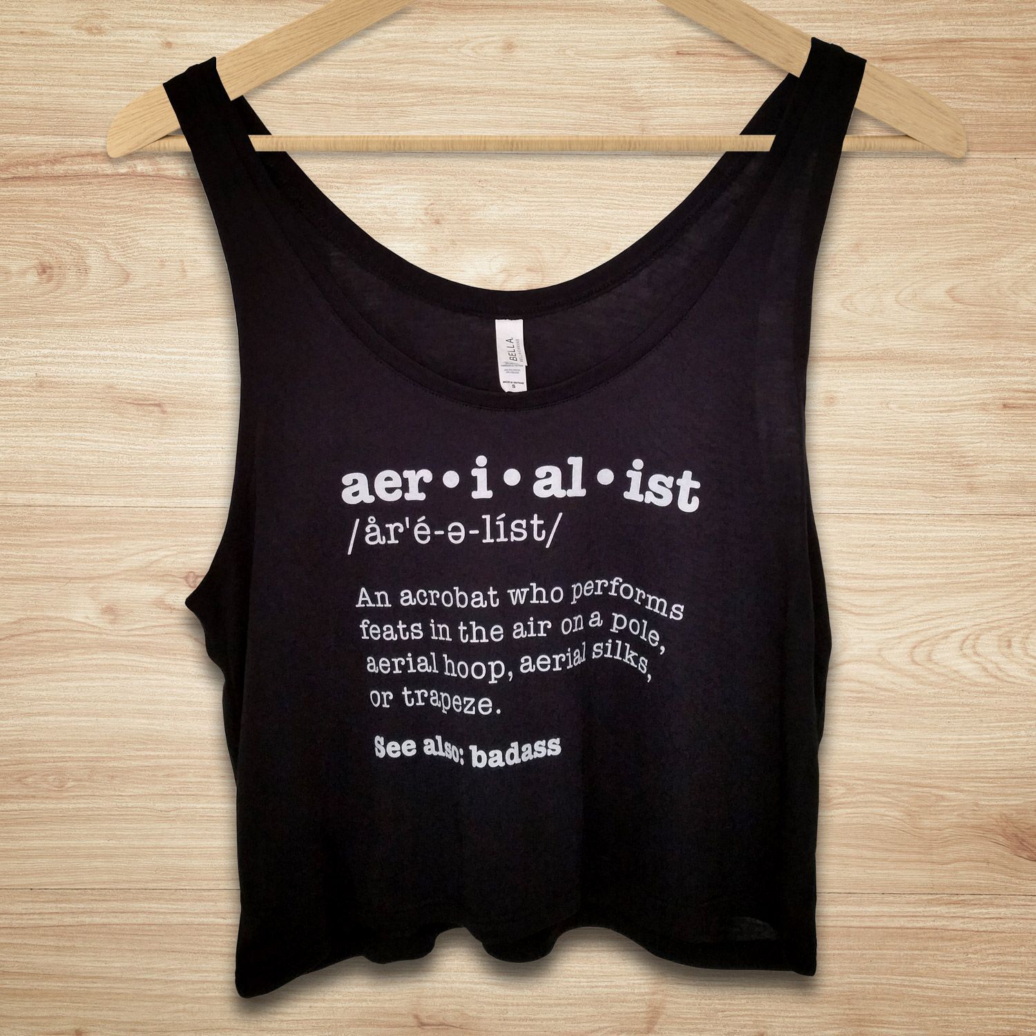 Aerialist definition crop top, perfect for pole dancers and aerial fitness enthusiasts!  Shirt reads: “Aerialist – an acrobat who