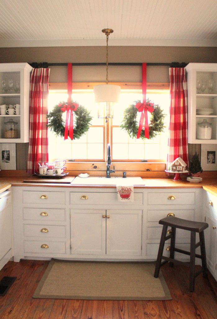 Buffalo check curtains add to the holiday charm and character of this festive farmhouse kitchen!