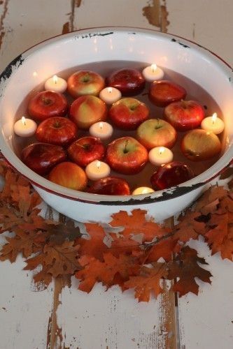 Halloween Party Decor: Floating candles & red apples.  www.partylite.biz/geminicandles