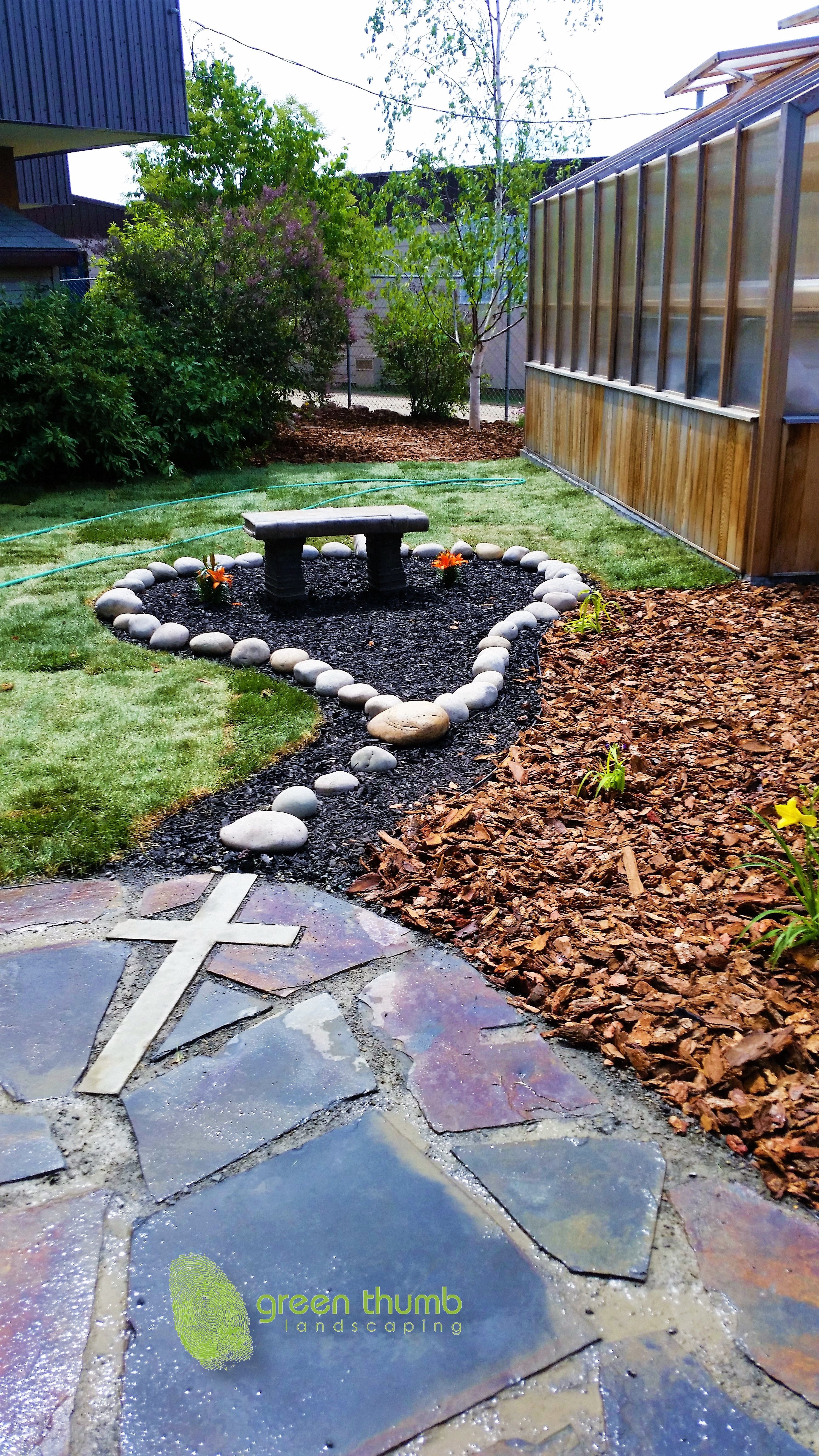 Rosary garden made for a Catholic elementary school. Using round washed rocks to create the rosary beads and a concrete cross cut