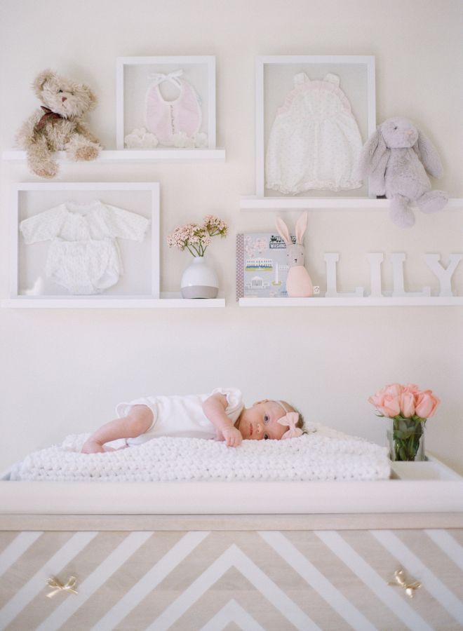 baby girl in her new blush nursery: http://www.stylemepretty.com/living/2016/12/02/a-blushing-baby-nursery-as-pretty-as-they-come/