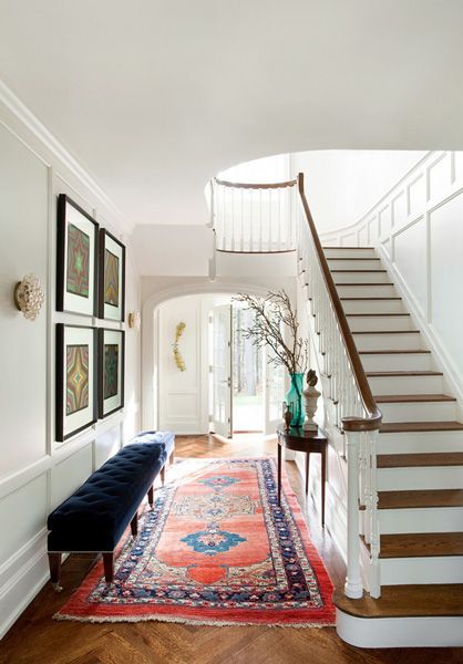 Designer Frank Roop used an oversize tufted bench to add an “unexpected or dramatic” element to the entryway of this