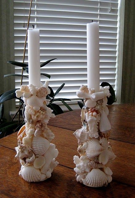 Hot glue shells and coral to wooden candle holders for a beach theme dinner table!