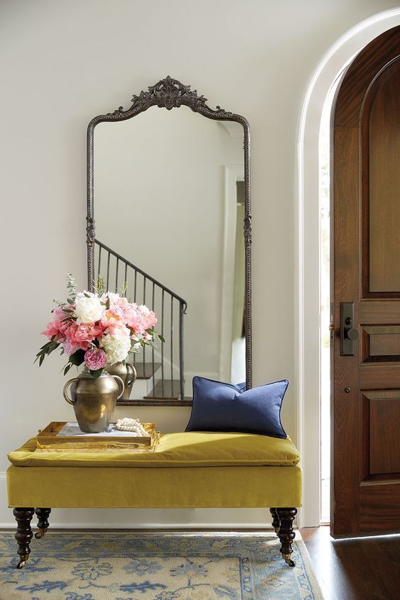 velvet bench in entryway with roses — via @TheFoxandShe