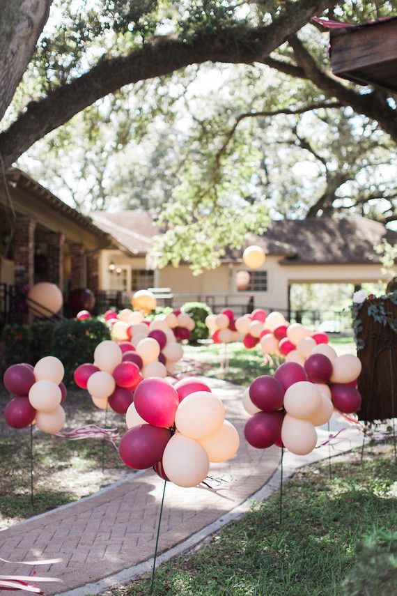 blush and marsala balloons lining a walkway for a party or a lively wedding