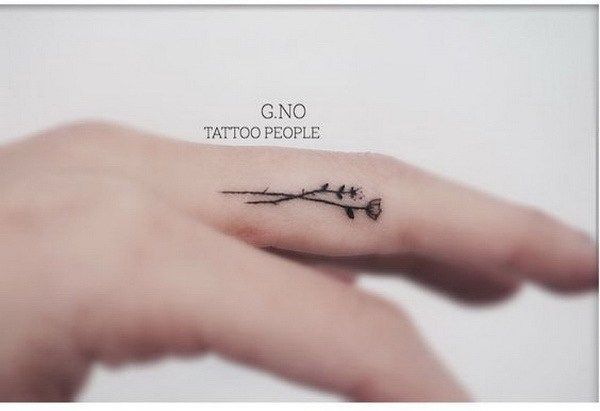 Tiny Flower Tattoo Inside of Finger.