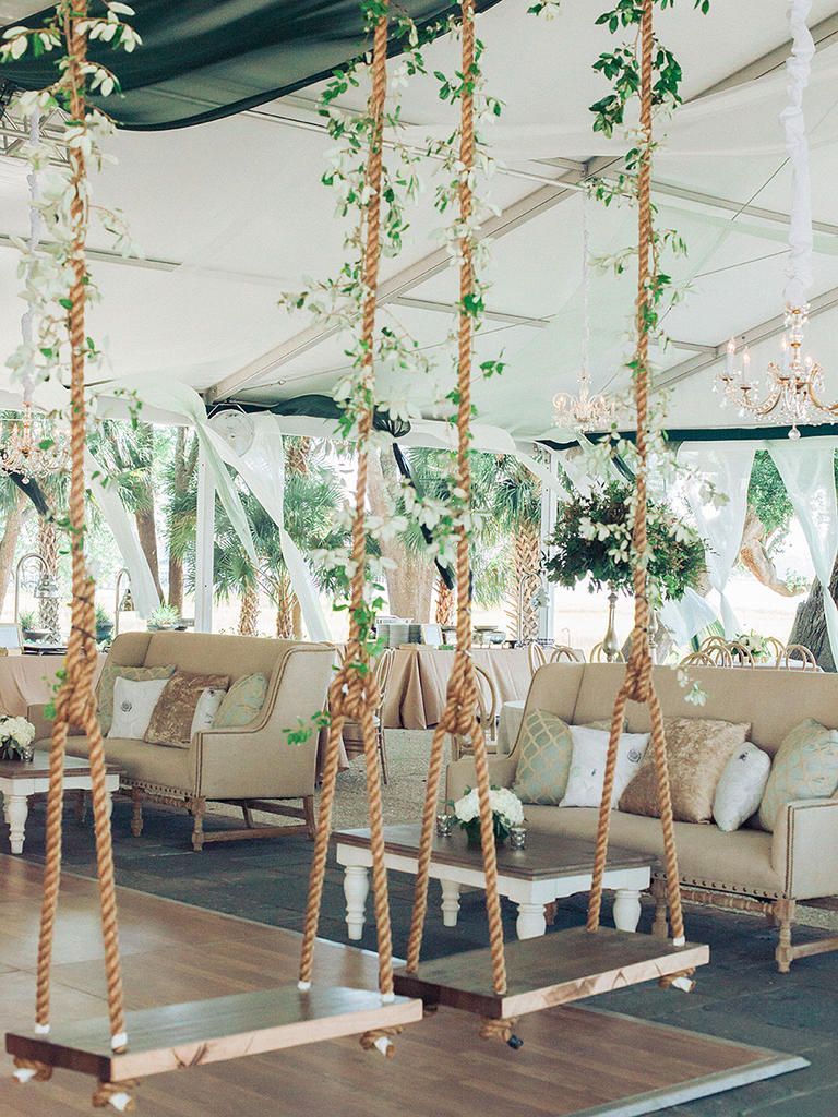 Channel the whimsy of a secret garden with floral wedding tent swings that make for stunning outdoor photo ops.