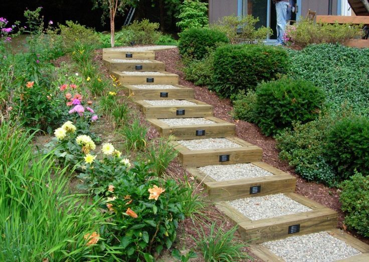 Classic and inexpensive.  4 x 4 railroad ties, hard gravel and lights make an attractive set of steps to make a hilly landscape