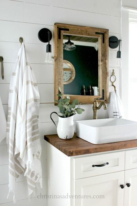 This vintage inspired farmhouse bathroom is filled with wood tones, mixed metals, shiplap, vintage treasures, and lots of DIY