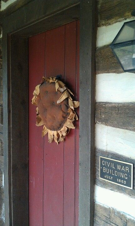 Front door in the late summer with a hanging sunflower that I made  LORI TRIPLETT -   25 primitive summer decor
 ideas