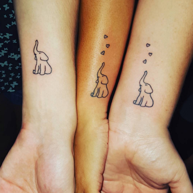 These tiny heart-adorned elephants are a TOO cute idea for a sibling tattoo. -   17 matching tattoo elephant
 ideas
