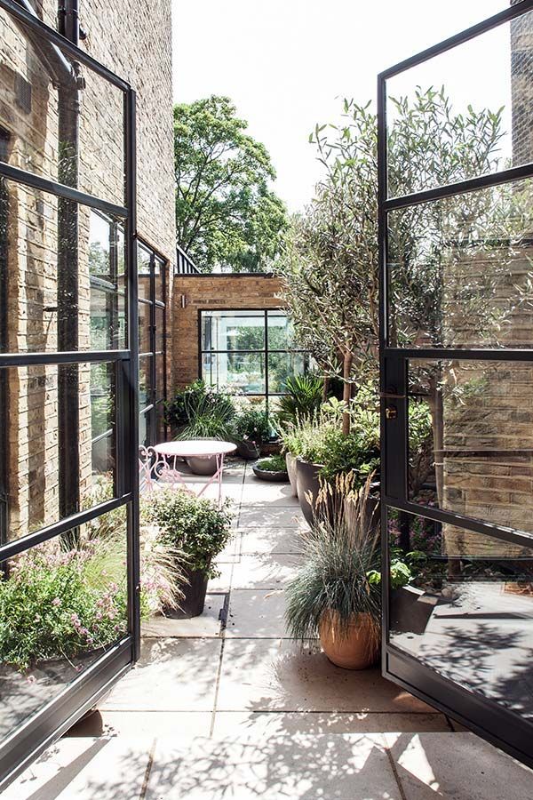 courtyard garden, black steel French doors, by Red Squirrel Architects -   22 victorian courtyard garden ideas