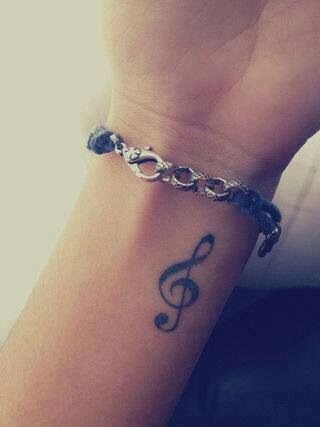I just want a basic treble clef on the side of my arm. But just the outline of it, I don't want it colored in black. -   23 music tattoo hand
 ideas