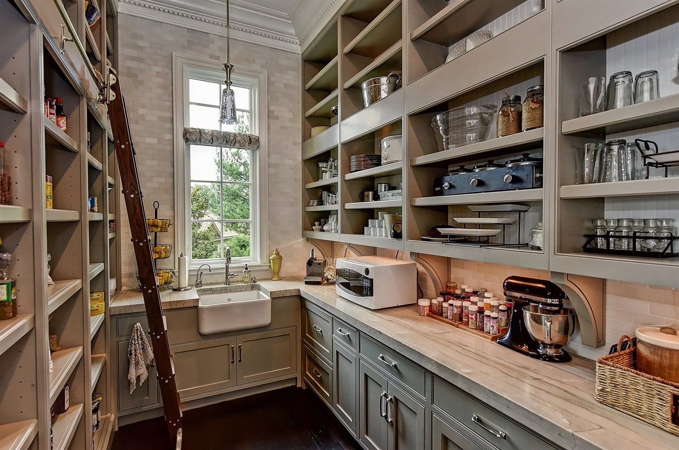 walk in pantry with a place for everything (food, glassware, china) and even a farm sink -   24 diy food pantry
 ideas