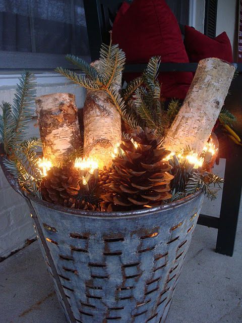 birch logs, greens, pinecones and white lights - classic! would be awesome with a non working fireplace mantel -   24 winter decor lights
 ideas