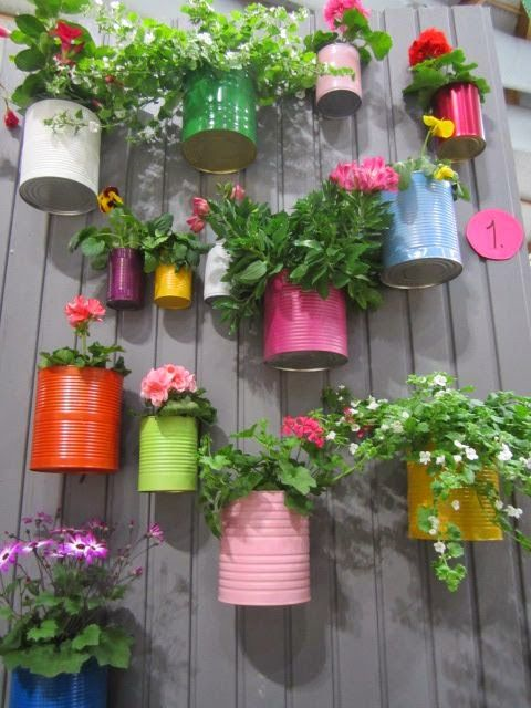 Paint recycled cans the colours of the rainbow and hook to your fence - easy herb garden. Check out the range of outdoor and spray paints at diy.com. -   22 garden decor fence
 ideas
