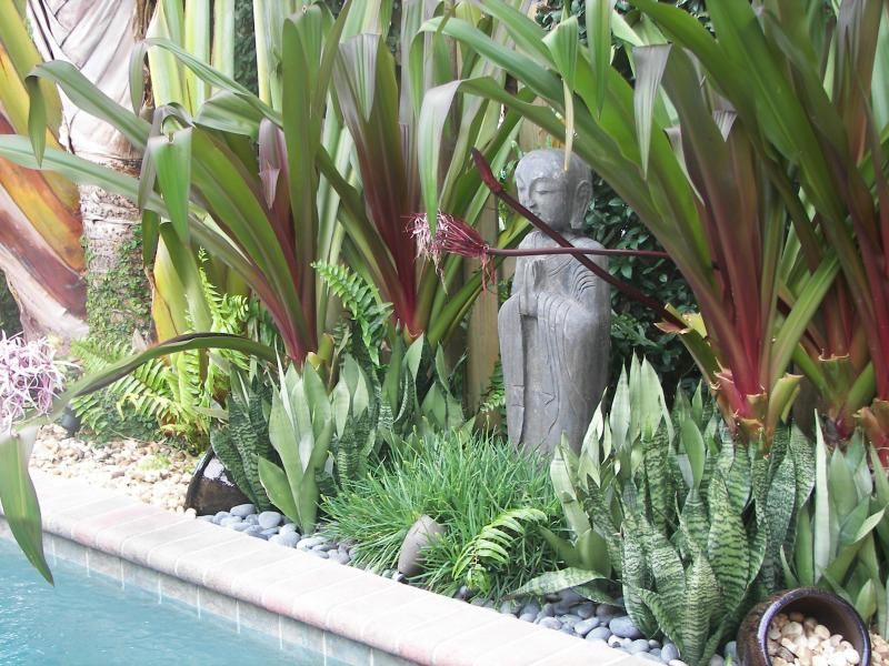 Florida Tropical Bali/Moroccan Oasis: Statue purchased from an import store in Miami.  It is from Bali and made from volcanic rock.  I thi -   23 tropical rock garden
 ideas