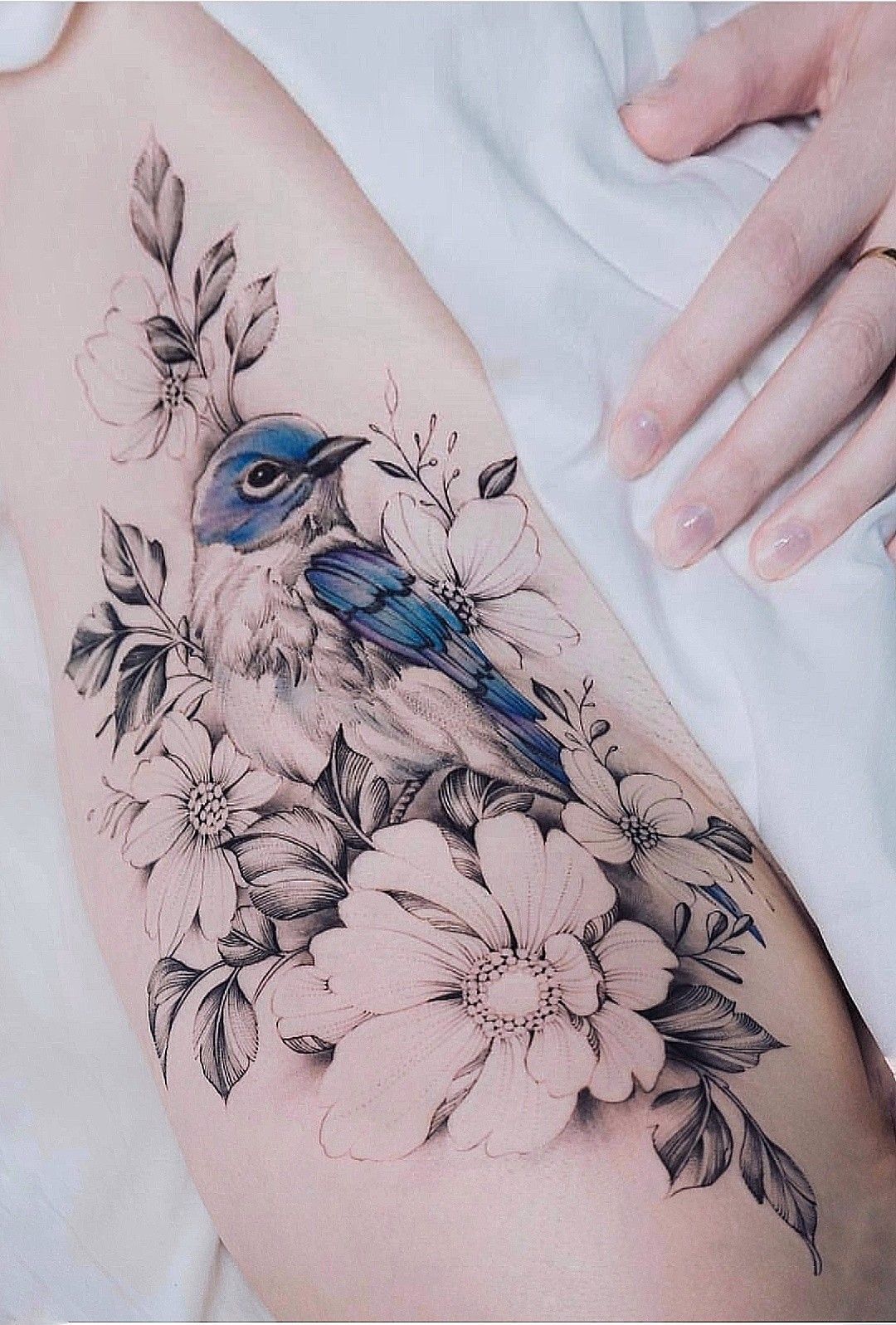 For floral tattoo, all the flowers are black & white, except for one. -   22 flower bird tattoo
 ideas