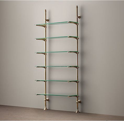 RH's 1930s French Bistro Shelving:Inspired by sleek 1930s shelving that once held dishes and glassware in a French bistro, our storage pairs adjustable glass shelves with cast brass poles that mount easily to the wall. -   24 glass shelves decor
 ideas